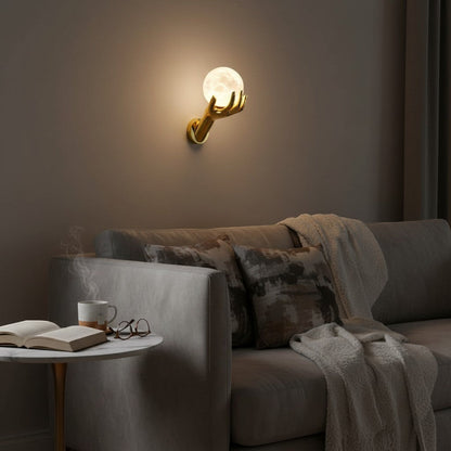 goodlampe gold resin hand holding moon-shaped frosted glass LED wall light